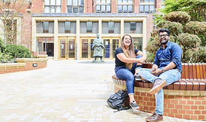 Students sitting outside the Armstrong Building.